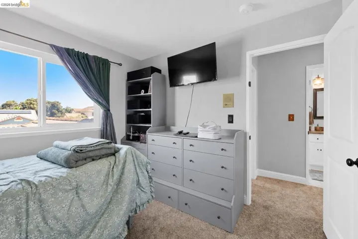 Carpeted room with a double-paned window, offering natural light