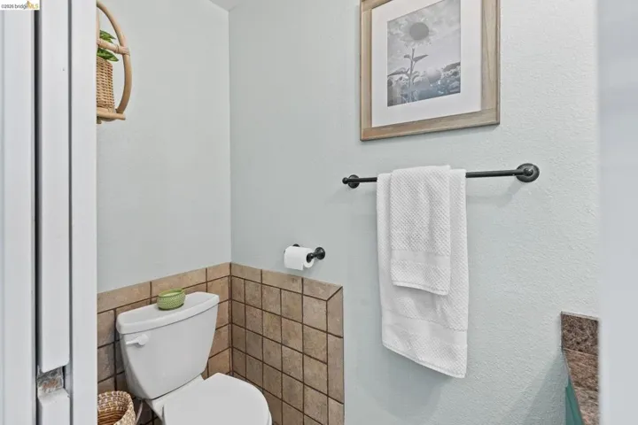 Ceramic tile wainscoting and light blue painted walls