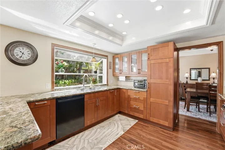 Thoughtfully designed with abundant storage and expansive counter space, the kitchen combines style and functionality while offering tranquil garden views.