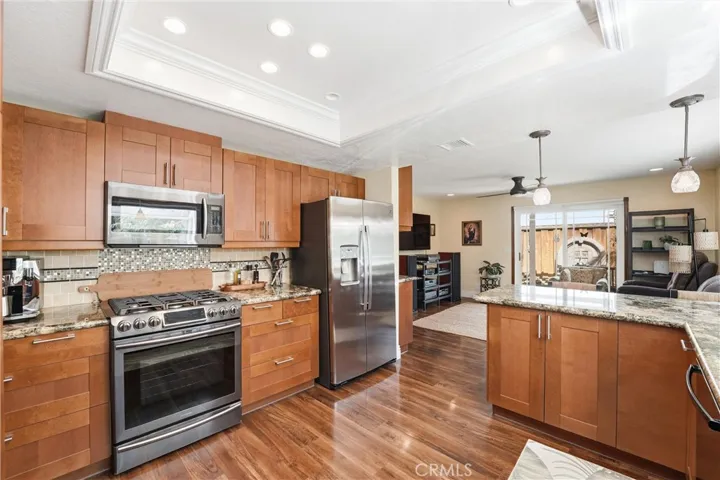 Stainless steel appliances, custom cabinetry, and generous workspace make this beautifully updated kitchen a standout feature of the home.