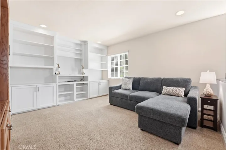 Versatile upstairs loft includes custom built-in shelving and cabinetry, providing excellent space for a media room, home office, or play area. Neutral finishes make it easy to personalize.