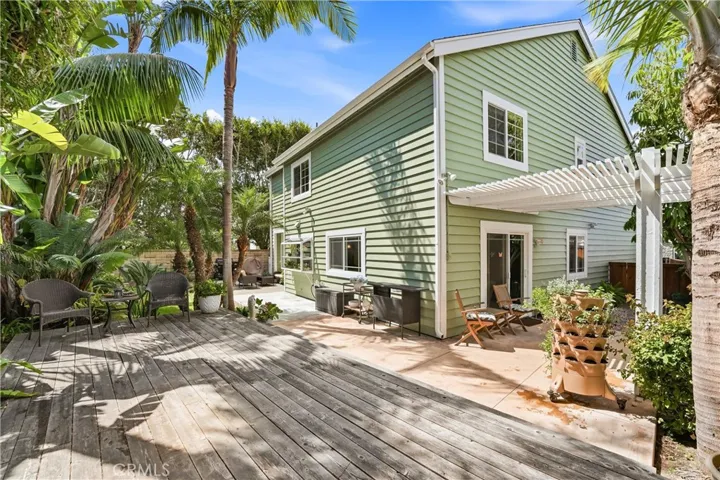 ear exterior showcases a spacious patio and deck combination framed by vibrant landscaping and palm trees. Multiple outdoor living areas make it easy to enjoy Southern California’s indoor-outdoor lifestyle.