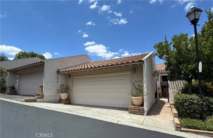 Front view of entry and 2 car garage