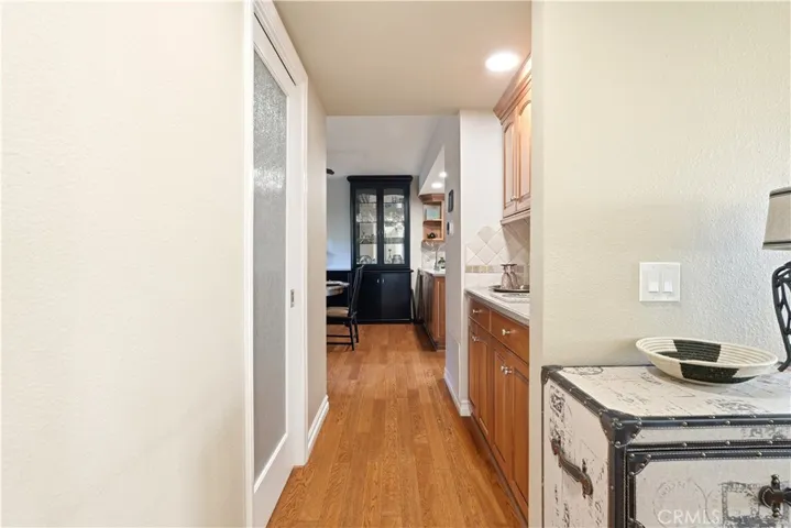 Hallway leading to restroom and dining area.