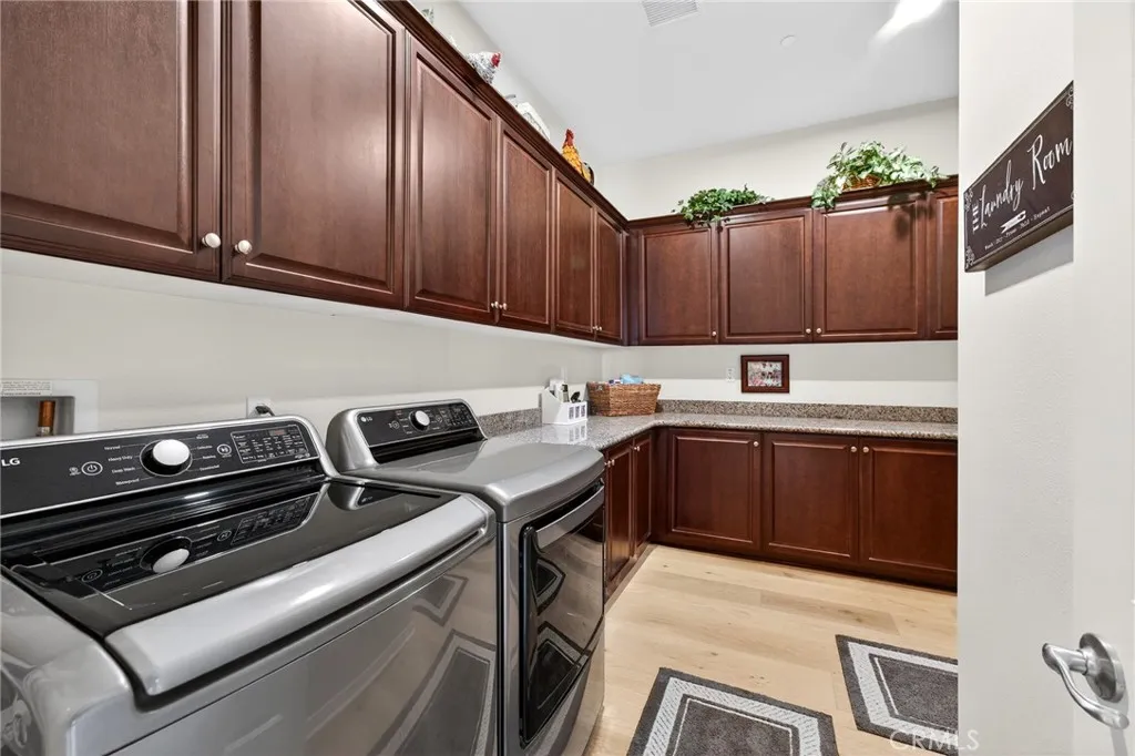 Huge Laundry Room with Cabinets Galore and Granite Countertops