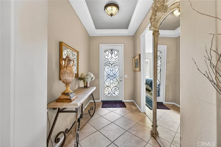 Gorgeous Glass and Wrought Iron Front Door, Cofferred Ceiling and Ceramic Tiled Flooring