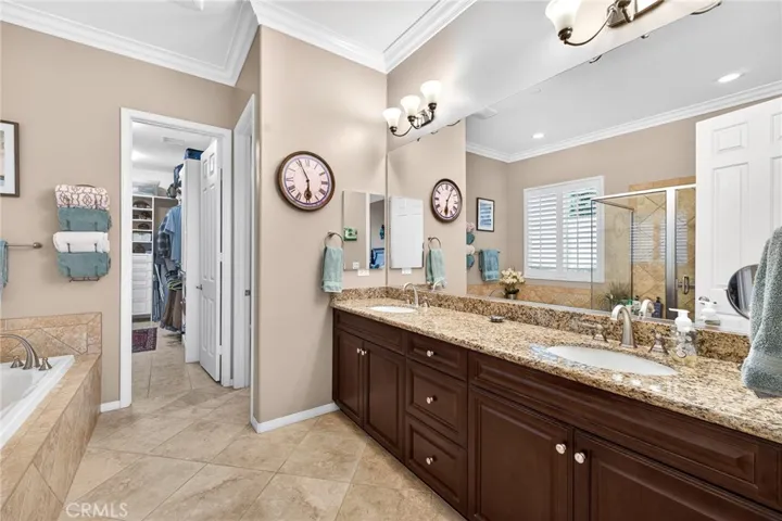 Double Sinks in Primary Bathroom and Huge Walk-in Closet is Organized with Self-Closing Cabinets, Drawers and Shelving