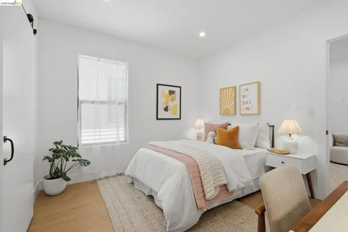 White-painted interior walls with recessed lighting and wood-finish flooring