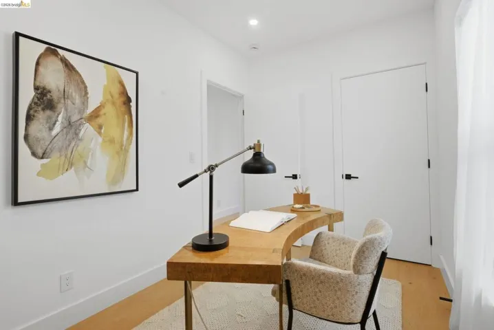 Room featuring light wood-finish flooring, white walls, and recessed lighting