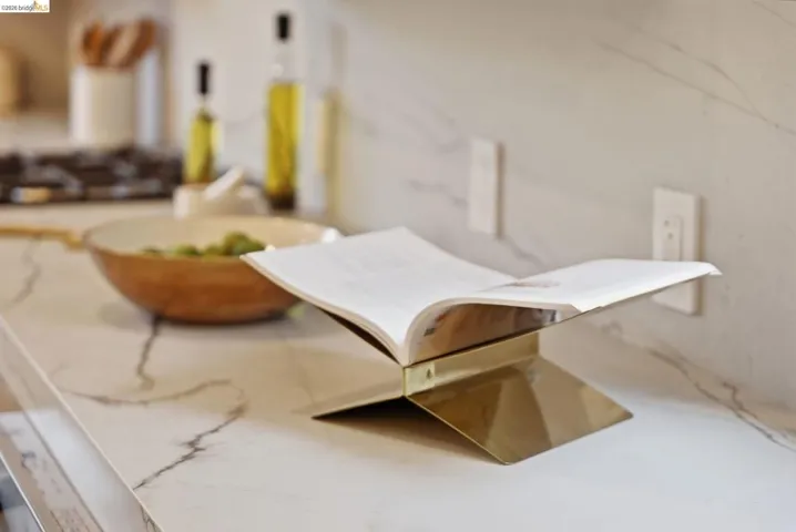 White countertop with gray veining and matching backsplash extending to the wall outlets