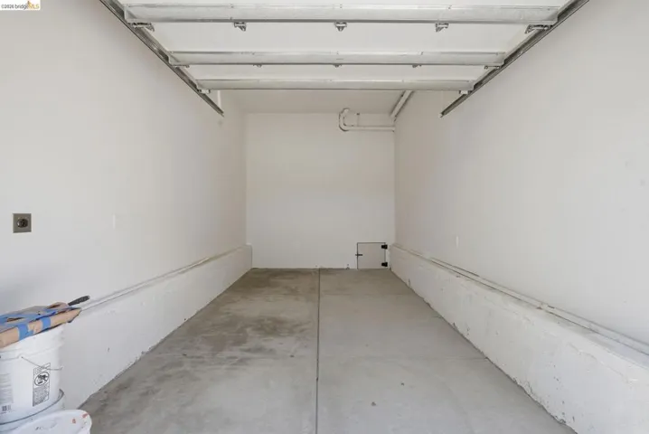 Spacious garage featuring concrete flooring and white painted walls