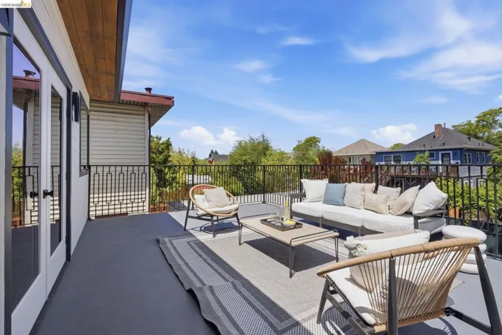 Expansive outdoor deck with dark gray flooring and black metal railings