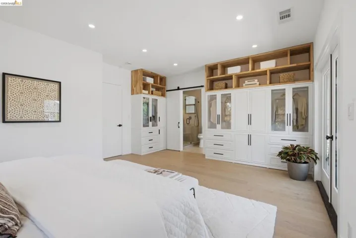 Light wood-finish flooring complements the crisp white walls and ceiling