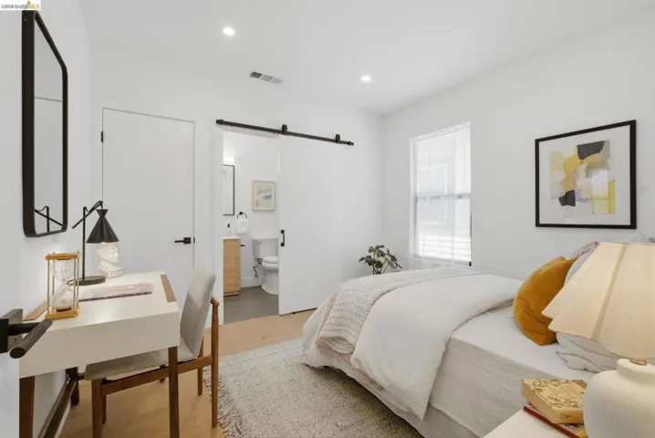 Bedroom featuring light wood-finish flooring, recessed lighting, and a window with blinds