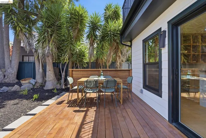 Spacious wood deck with surrounding landscaping and mature trees