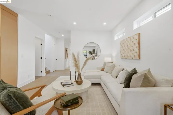 Open-concept living space featuring high ceilings, recessed lighting, and light wood-finish flooring