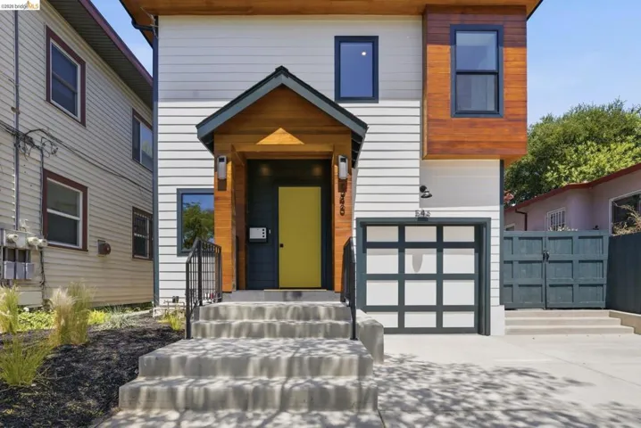 Modern two-story facade featuring horizontal siding and wood-finish accents