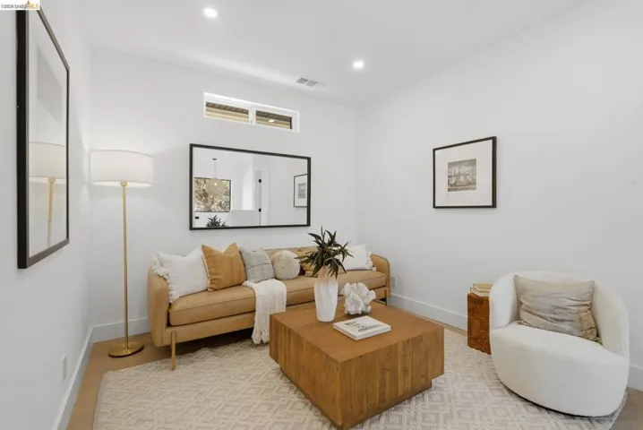Living area featuring a transom window, recessed lighting, and wood-finish flooring