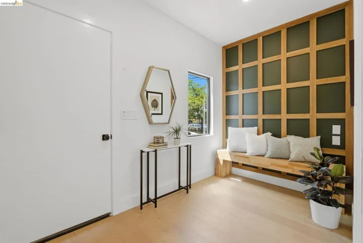 Entryway featuring wood-finish flooring and a built-in wooden bench