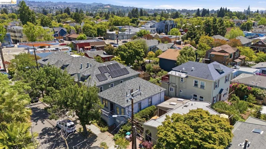 Aerial perspective showcasing residential properties with varied architectural styles and mature tree canopies