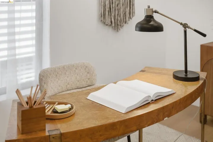 Curved wood-finish desk featuring metal accents