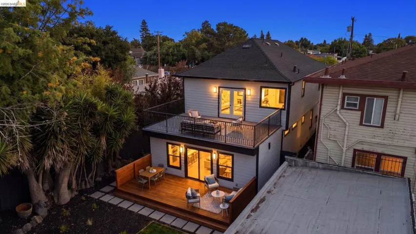 Rear exterior featuring two levels of outdoor living space