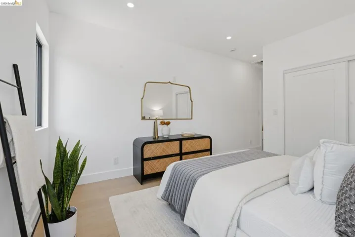 Bright room featuring neutral wall tones, recessed lighting, a window, wood-finish flooring, and white trim