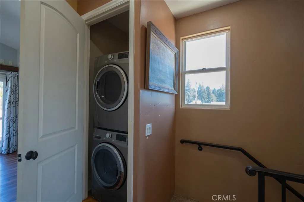 Stackable washer and dryer located in the hall closet.
