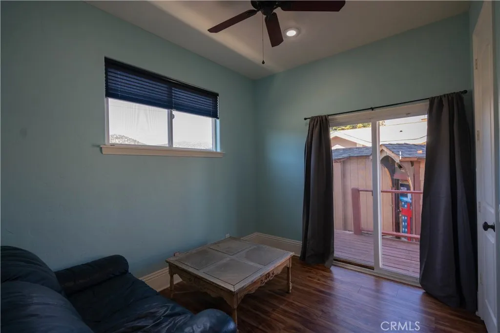 Main-level room featuring a walk-in closet and convenient backyard access; versatile floor plan ideal for use as a bedroom or home office.