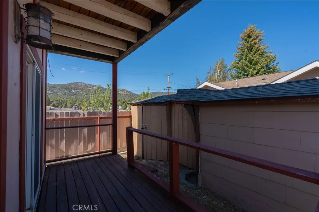 Spacious back porch featuring extensive built-in storage.