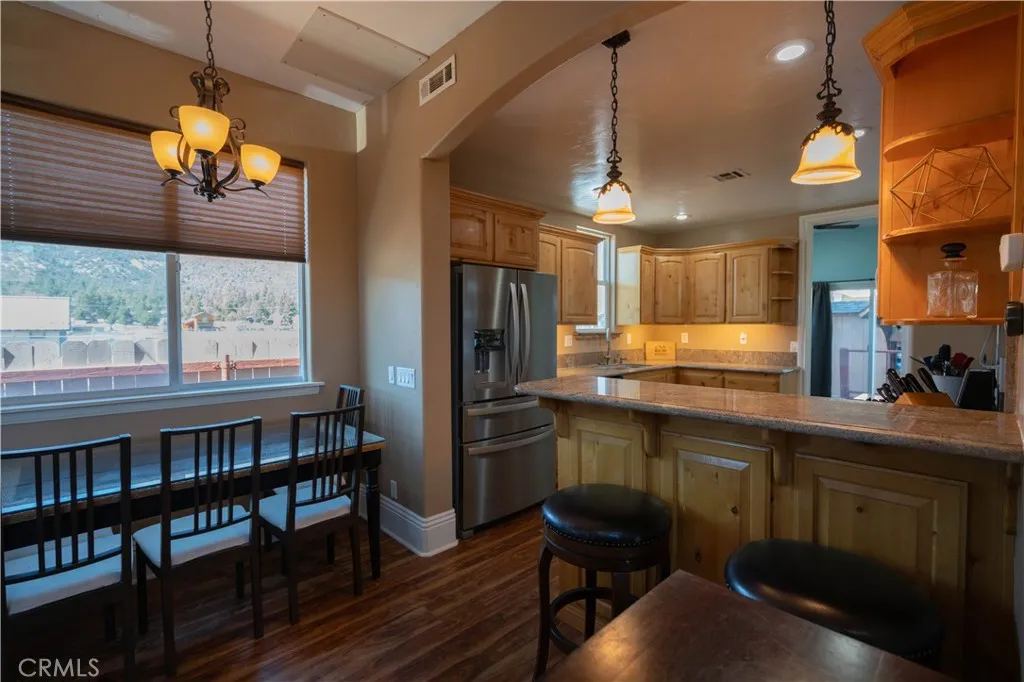 Bright, open-concept dining area featuring a breakfast bar.