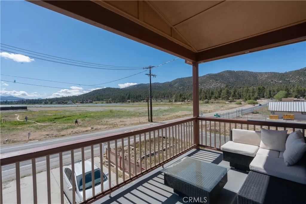 Master bedroom balcony featuring ample space for outdoor furniture, perfect for relaxing while enjoying the stunning lake and mountain views.