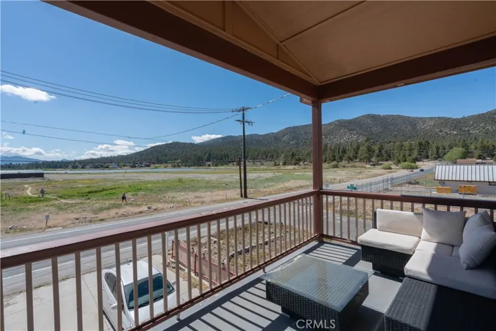 Master bedroom balcony featuring ample space for outdoor furniture, perfect for relaxing while enjoying the stunning lake and mountain views.