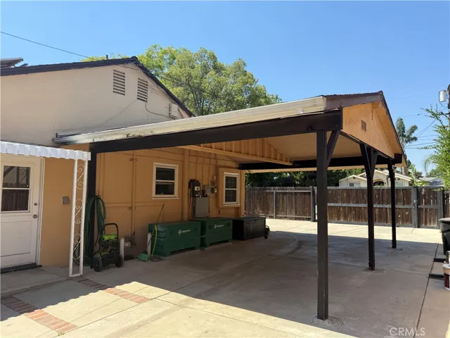 wide drive way with a carport or outdoor sitting area