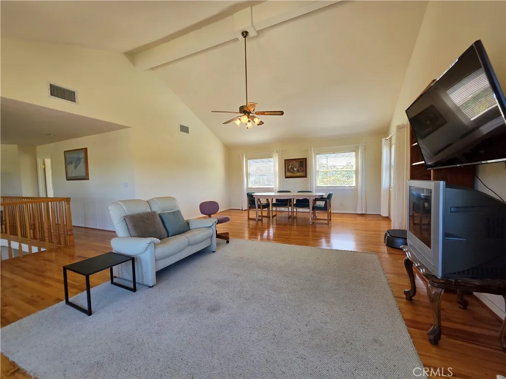 Upstairs vaulted loft/bonus room with hardwood floors