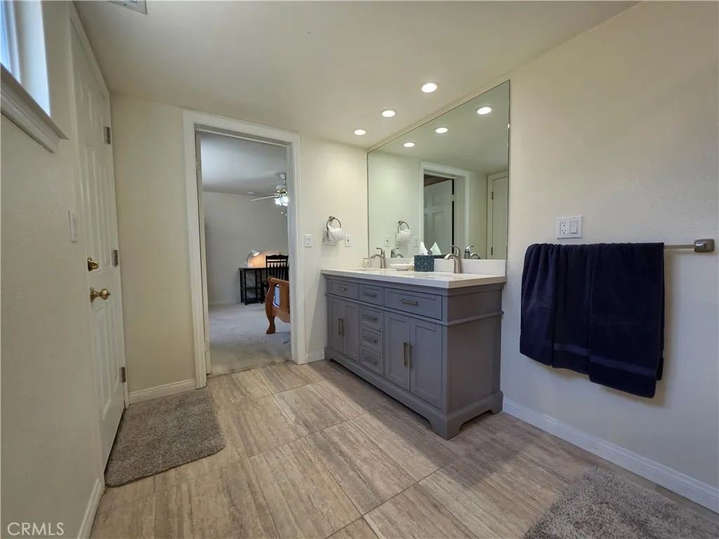 En-suite bathroom to 2nd main level primary bedroom with 2 sinks