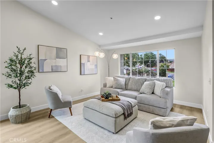 The living room is filled with natural light and offers a comfortable space to relax or welcome guests.