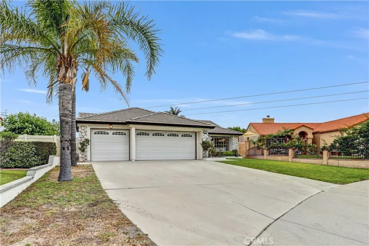 From the moment you arrive, the mature palm trees and spacious front approach give this home a warm and inviting feel.