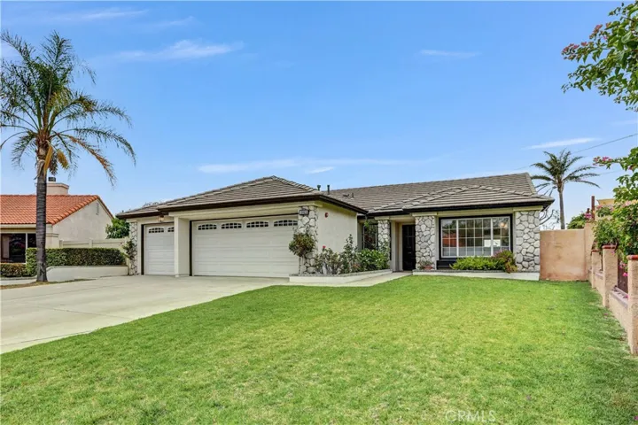 The front lawn and stone-accented exterior create a beautiful first impression and make this home feel welcoming right away.