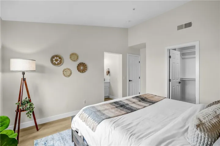 The primary bedroom feels peaceful and inviting with vaulted ceilings, updated flooring, and soft neutral tones.
