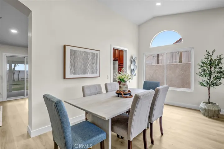 The dining area feels bright and open with vaulted ceilings, updated flooring, and plenty of room to gather.