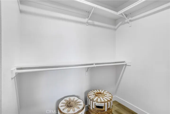 The walk-in closet provides practical storage with built-in shelving and plenty of hanging space.