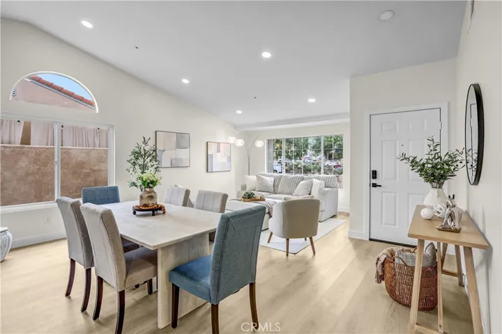 Step inside to a bright, open living and dining space with updated flooring, recessed lighting, and a fresh modern feel.