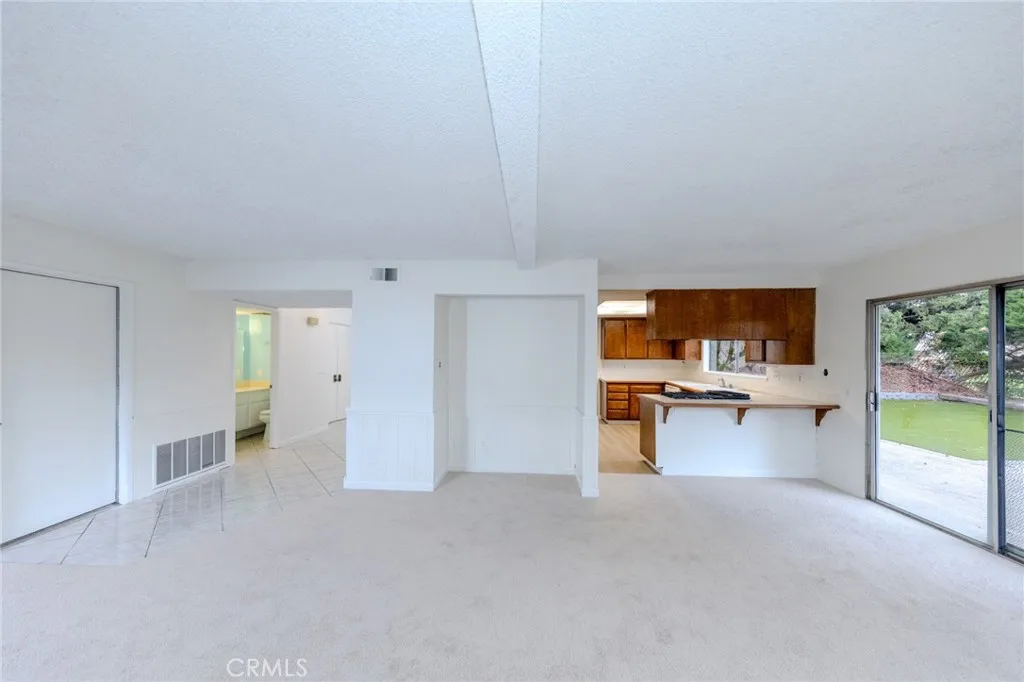 Family room has a nook for entertainment center and easy access to two car garage with washer/dryer hook ups.