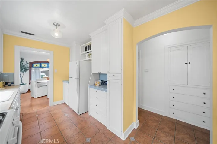 The kitchen connects with the hallway and linen closet.