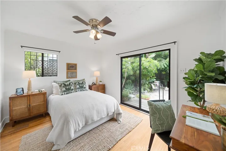 Back bedroom is filled with natural light and has views of the lushly landscaped backyard.