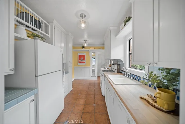 Galley kitchen with pretty tile flooring.