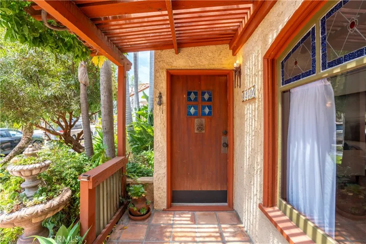 Wood door with stained glass greets you and your friends.