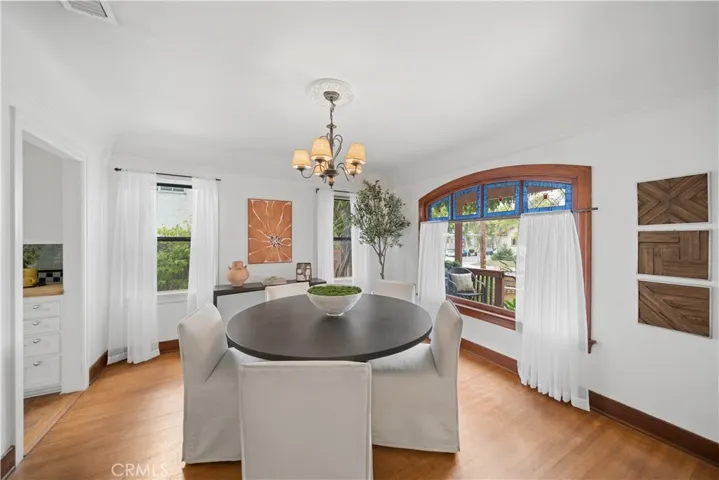Inviting dining room with large, arched window true to the period.