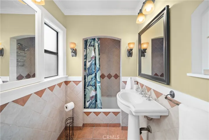 Full bathroom with pedestal sink and dual windows. An additional linen closet is also available (not in the photo)
